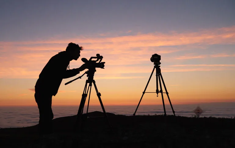 A photographer reviewing shots on a camera during a client session